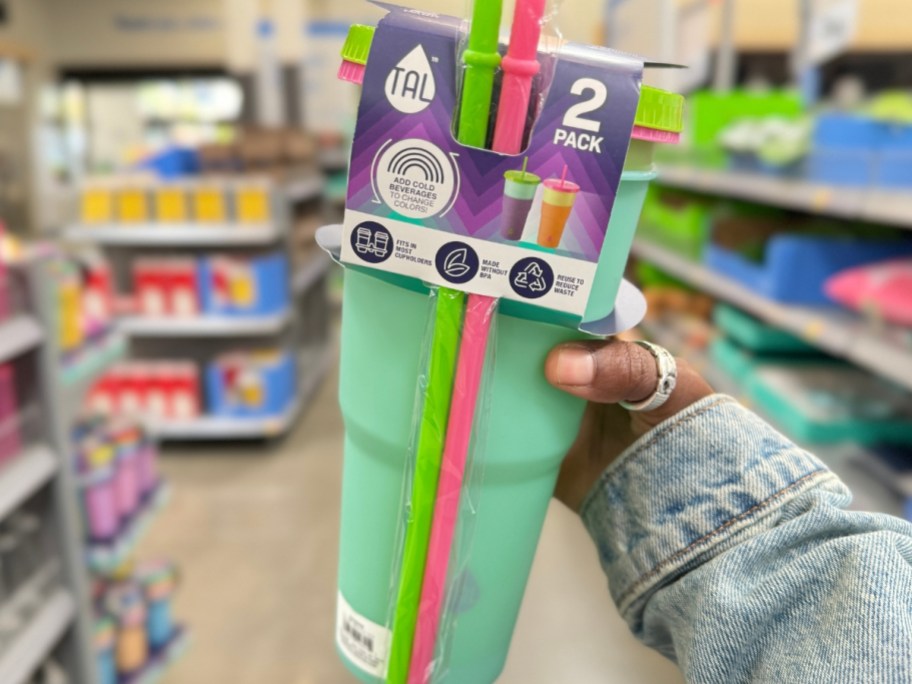 hand holding a 2 pack of colorful tumblers with straws