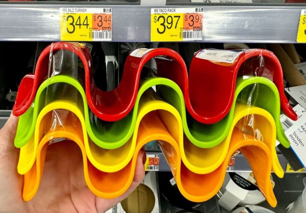 hand holding colorful red green yellow orange wavy taco holders in front of store shelf