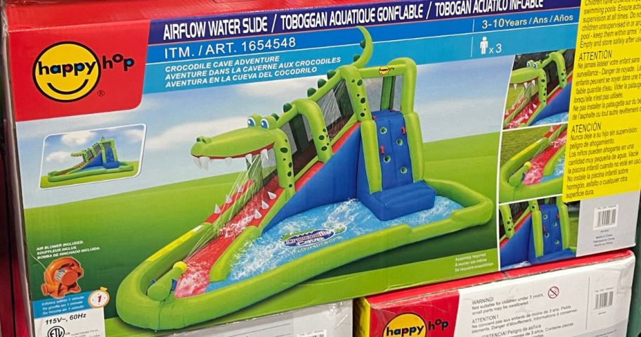 the box for a crocodile themed inflatable backyard water slide