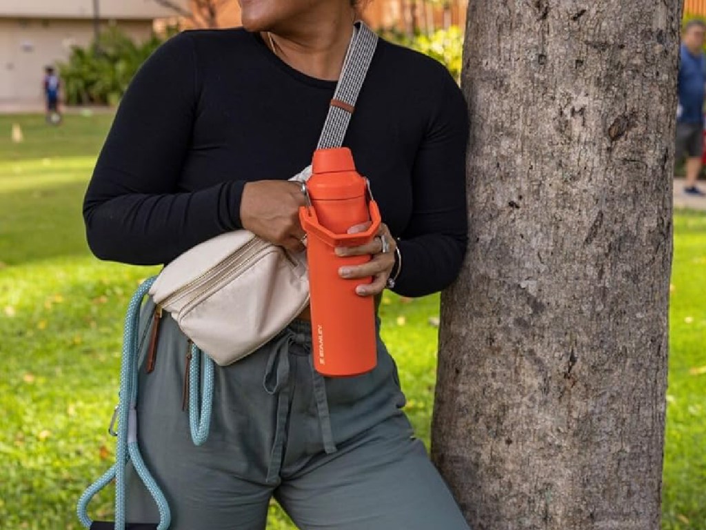 https://hip2save.com/wp-content/uploads/2023/12/woman-holding-Stanley-IceFlow-Fast-Flow-Bottle-in-Tigerlily-while-standing-outside.jpg?resize=1024%2C768&strip=all