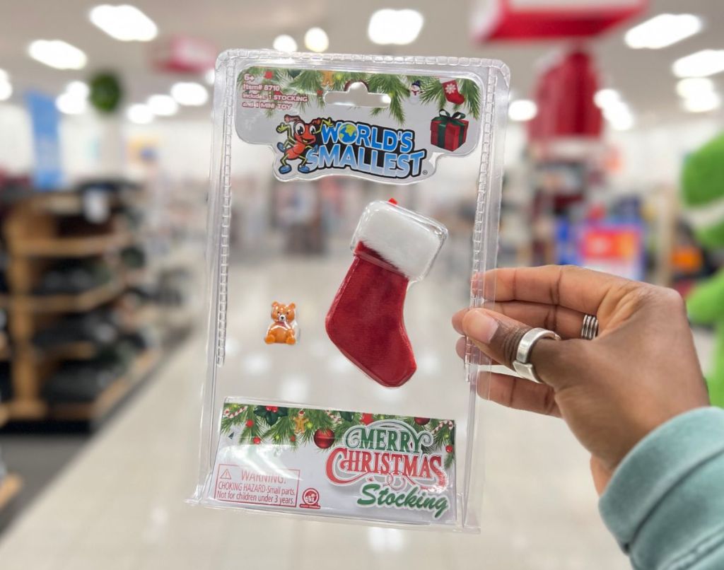 a womans hand displaying the worlds smallest christmas stocking