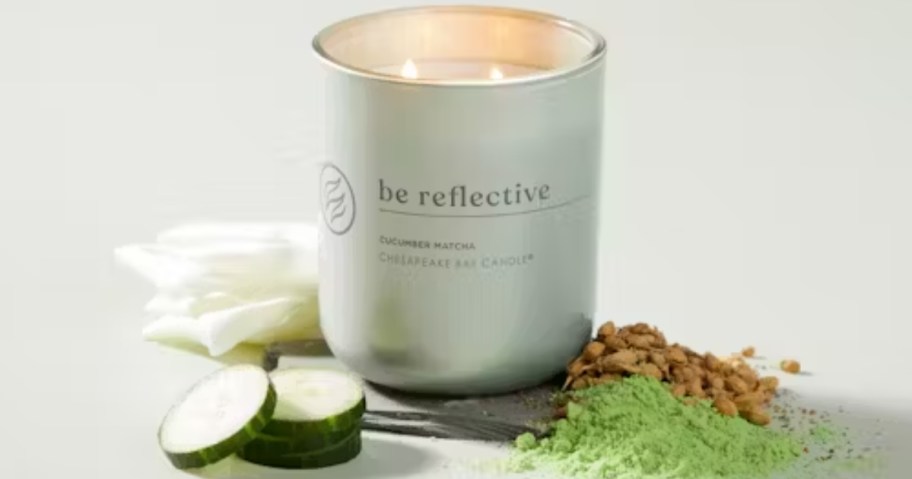 green yankee candle that says "be reflective"