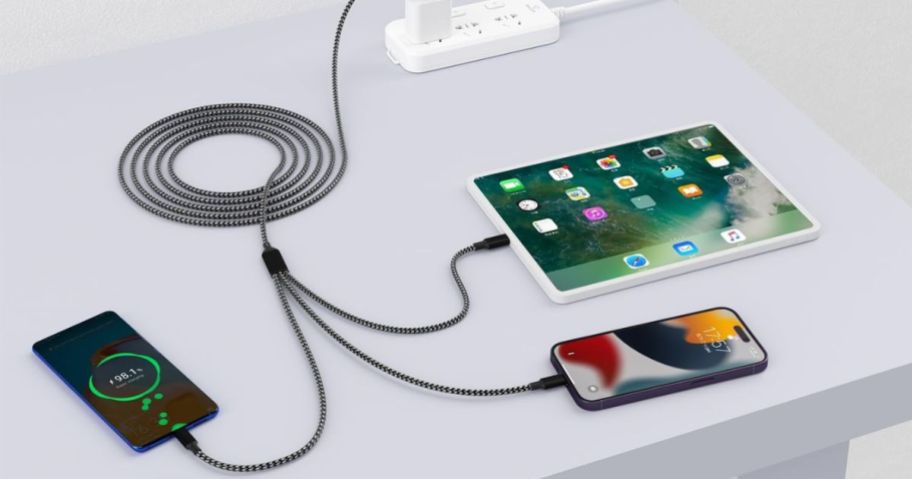 multi-charging USB cable in grey shown hooked up to 3 different devices at the same time