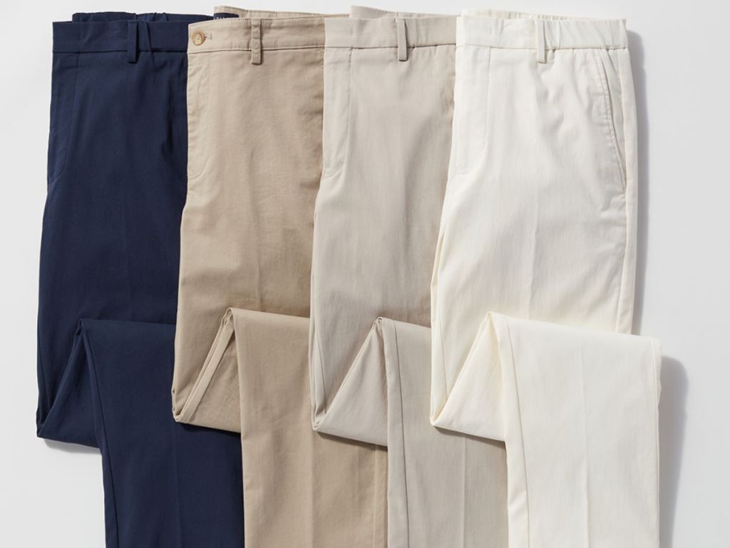 4 pairs of different color men's dress pants laid out