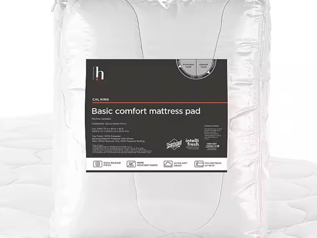 mattress pad in package sitting on top of a mattress with the pad on it