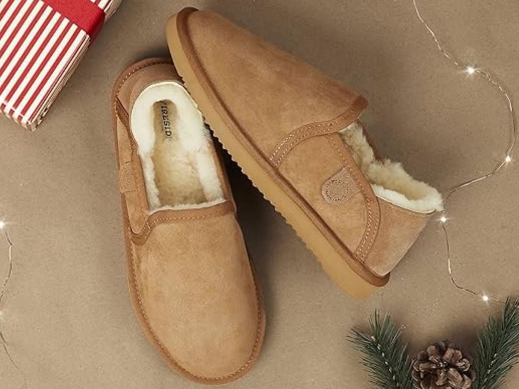 pair of tan men's Dearfoams slippers with white shearling lining