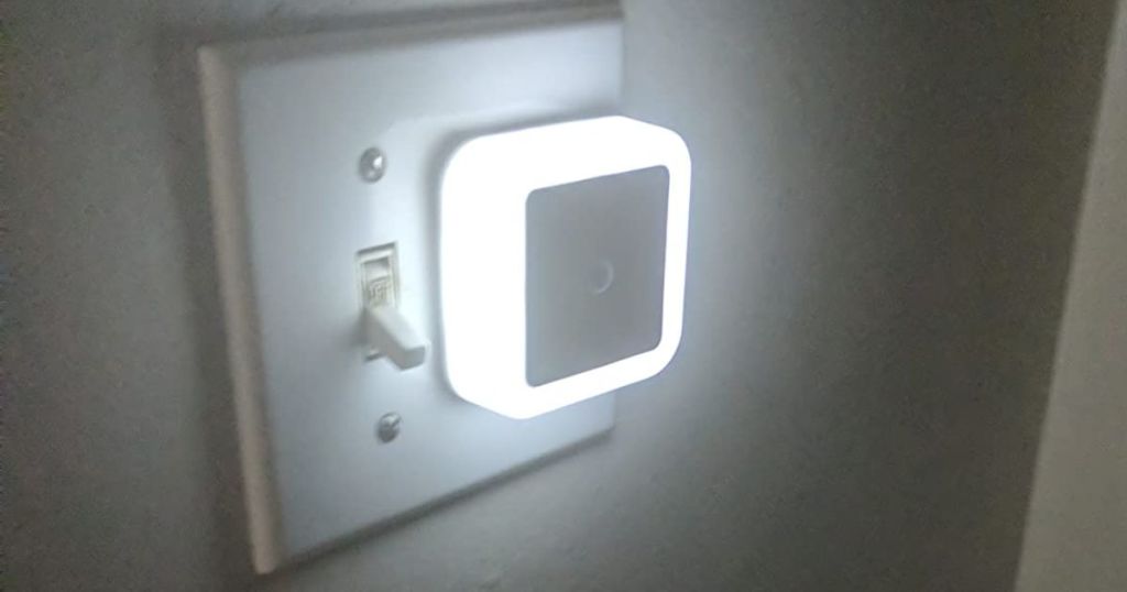 small white square nightlight plugged into outlet