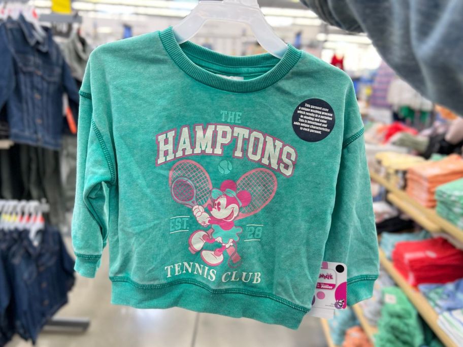 hand holding a toddler's green Minnie Mouse Hamptons Tennis Club vintage wash sweatshirt