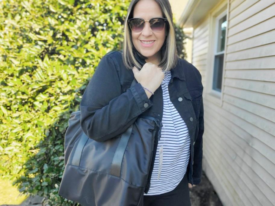 woman wearing black tote outdoors