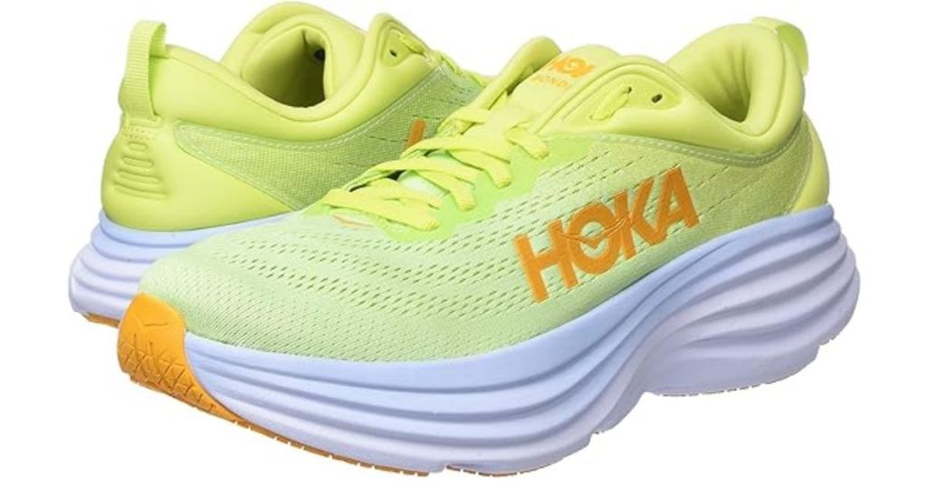 pair of bright yellow and orange Hoka men's shoes