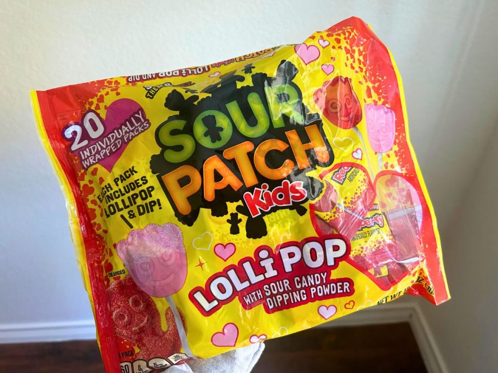 hand holding bag of Sour Patch Kids Valentine's lollipops