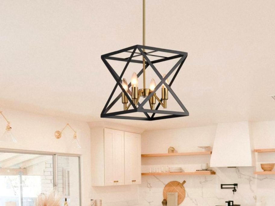 a 4 light black square metal chandelier hanging over a kitchen island