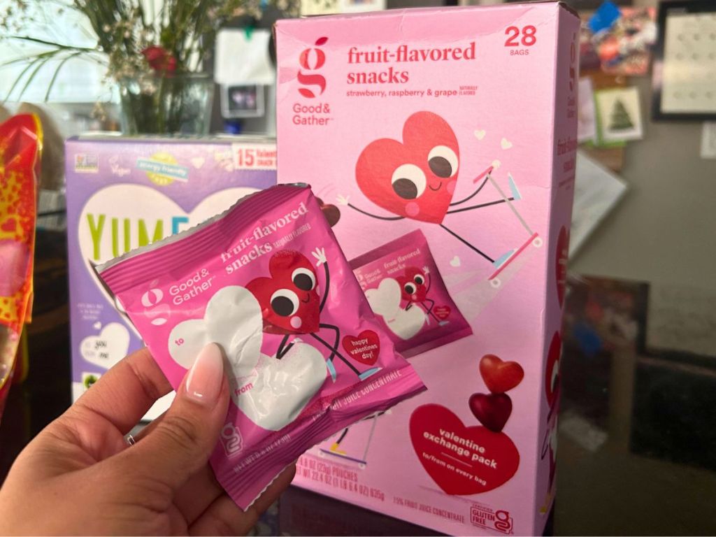 hand holding individual packet of a Good & Gather Valentine's Fruit Flavored Snack with box in background