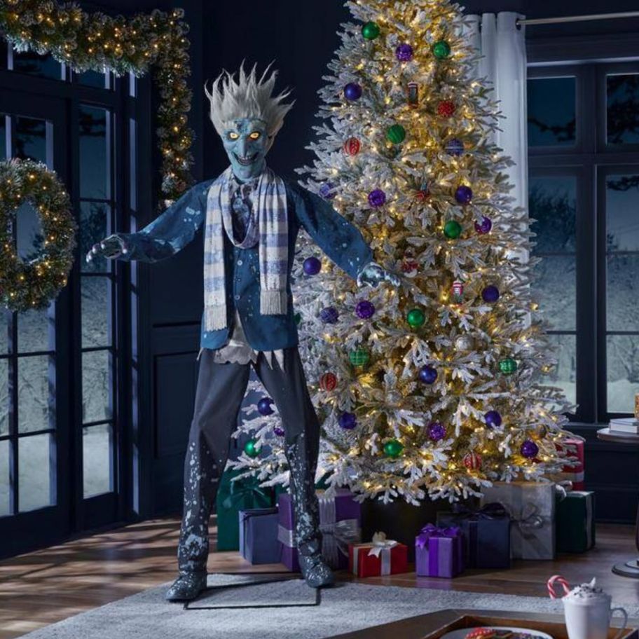 animatronic jack frost next to a decorated christmas tree