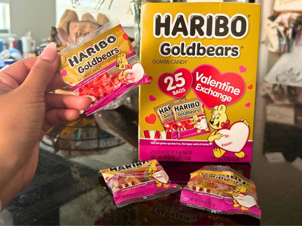 hand holding packet from Haribo Valentine's Goldbears Gummi Candy with box and other packets