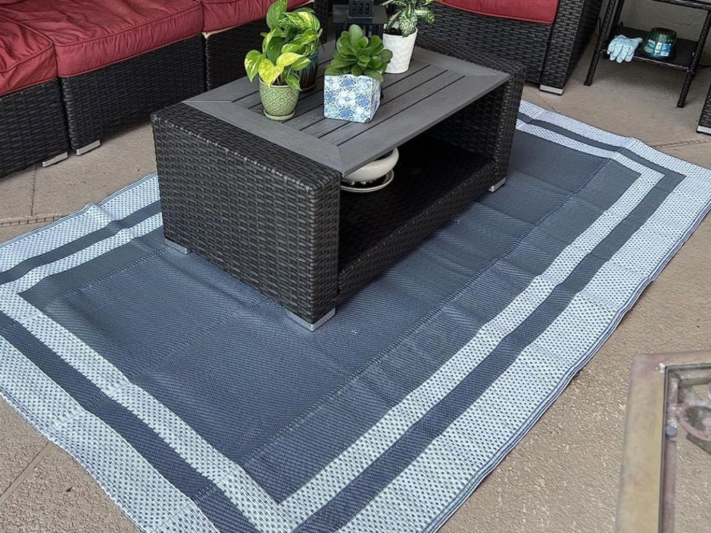 grey and white outdoor rug under outdoor coffee table on patio