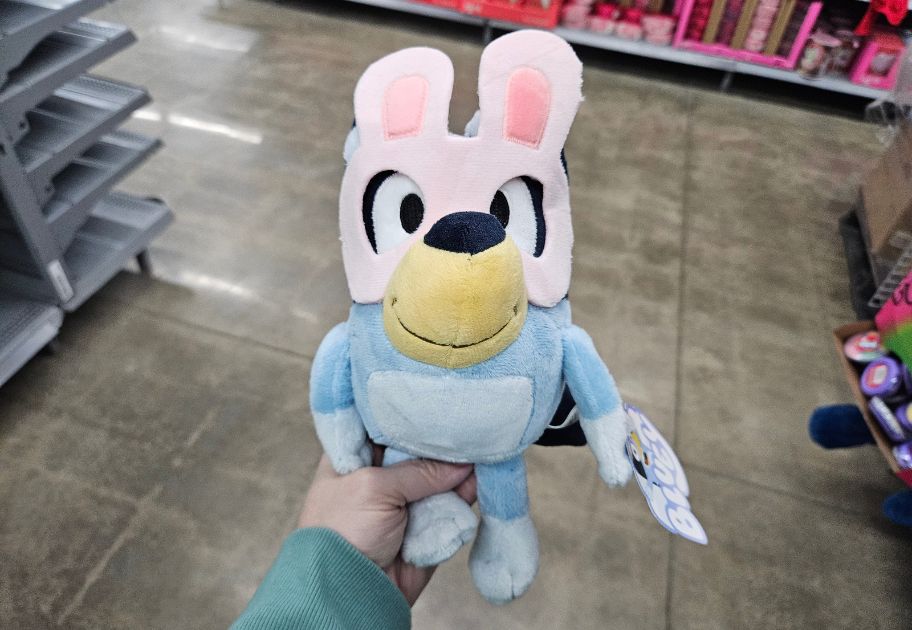 person's hand holding a Bluey Easter Plush at Walmart