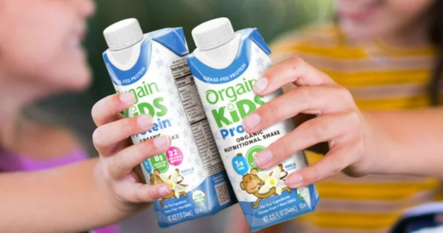 kids holding Orgain Organic Kids Protein shakes