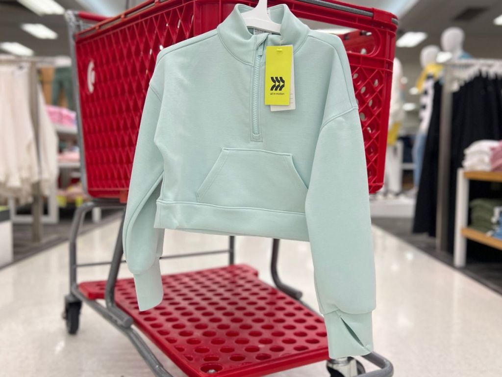 All in Motion Girls 1/2 Zip Pullover hanging on a Target Shopping Cart