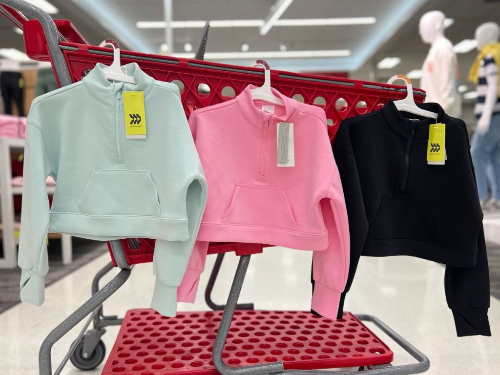3 All in Motion Girls 1/2 Zip sweatshirts hanging on a Target shopping cart