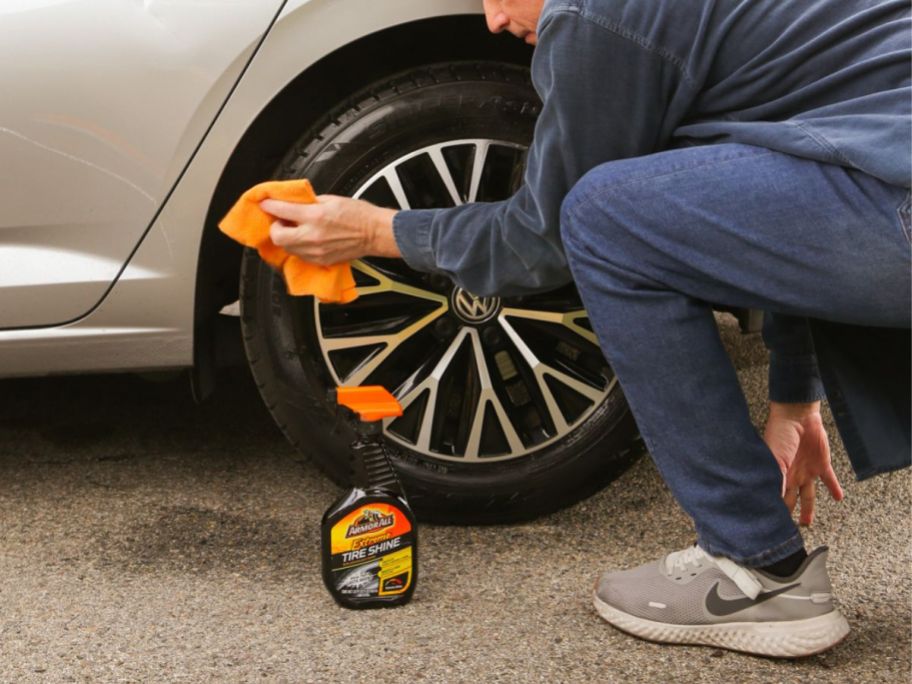 man cleaning his tire using Armorall Tire Cleaner