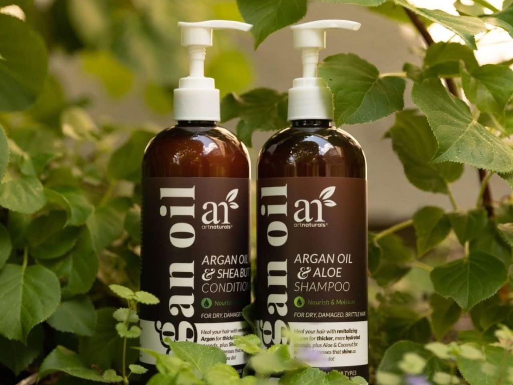 ArtNaturals Argan Oil Shampoo & Conditioner Set surrounded by greenery