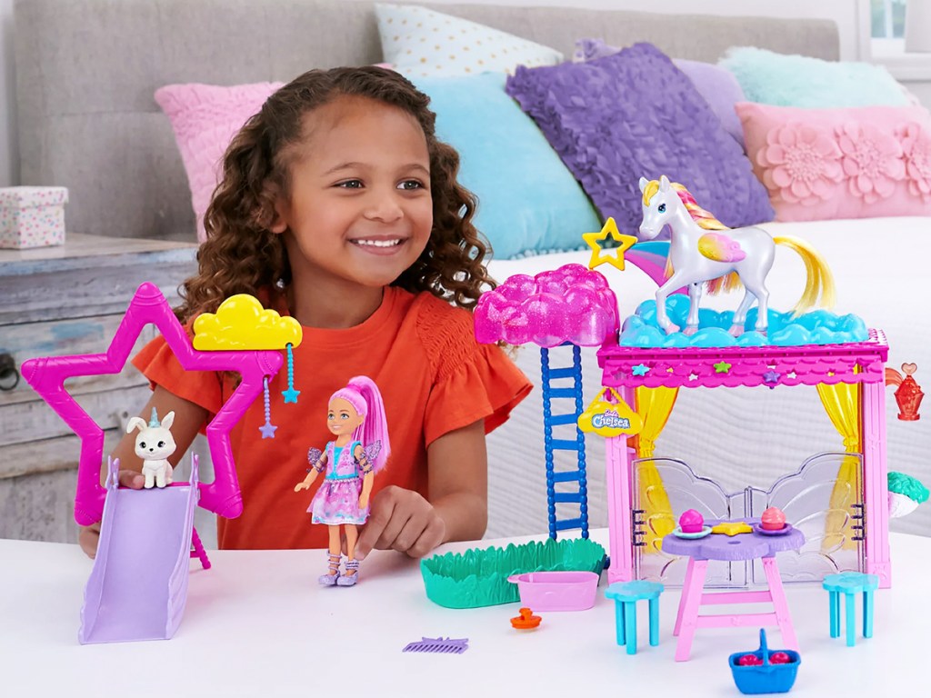 girl playing with barbie chelsea doll playset