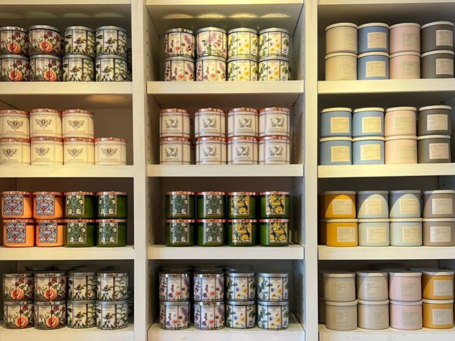 A wall of shelves containing 3-wick candles at Bath & Body Works
