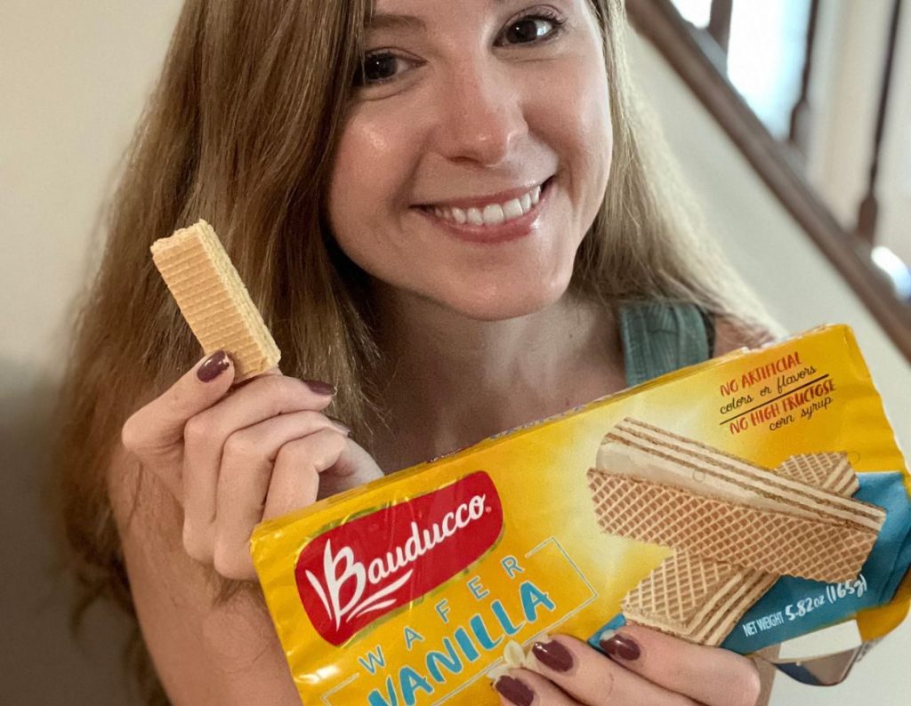 Woman holding a pack of Bauducco wafers