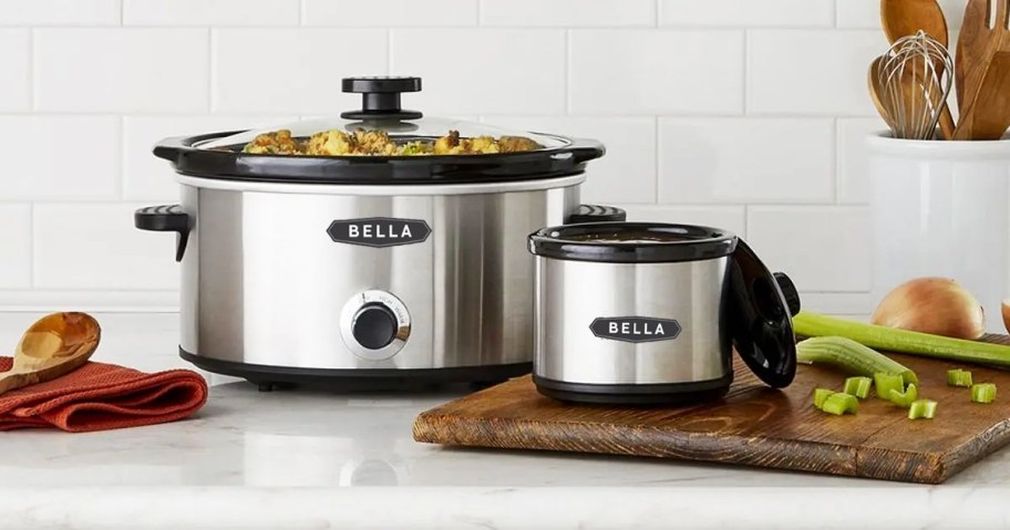 stainless steel slow cooker and matching mini slow cooker on kitchen counter with food