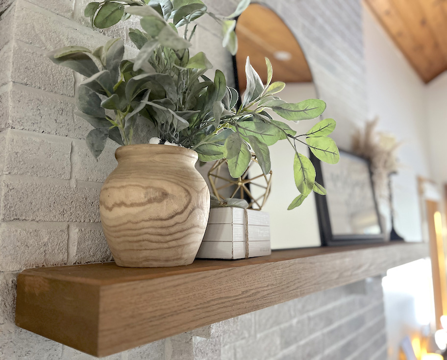 close up of wood vase with greenery