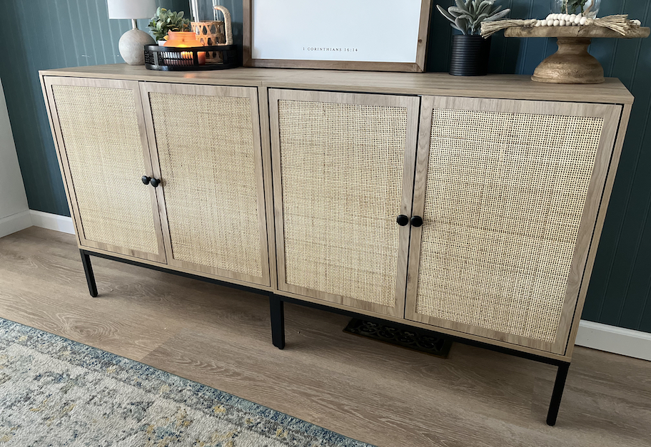 close up of caned sideboard on wood floor