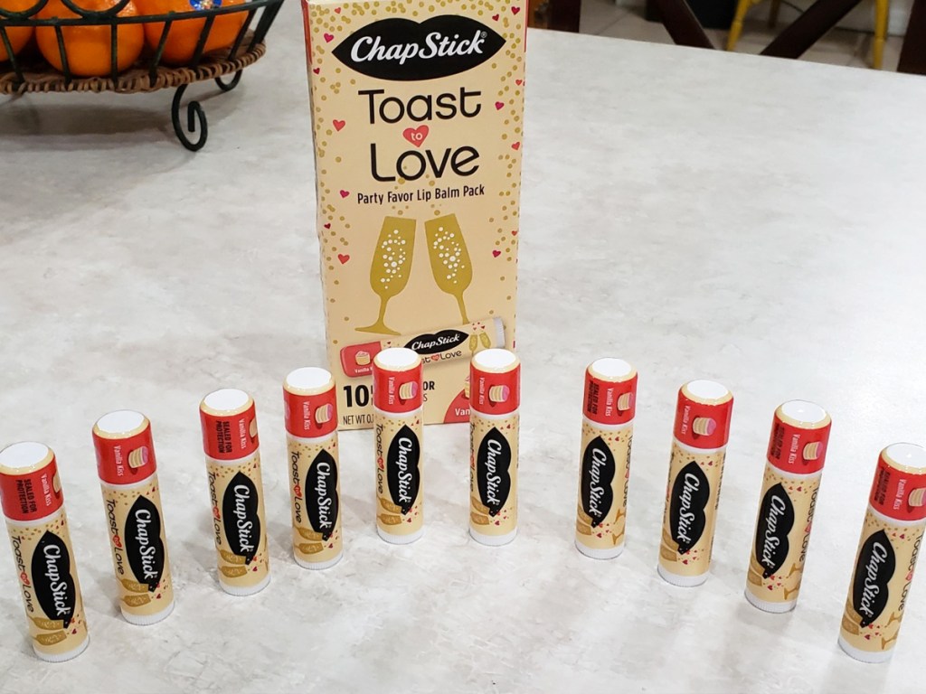 10 ChapStick lip balms in row on kitchen counter with ChapStick box behind them