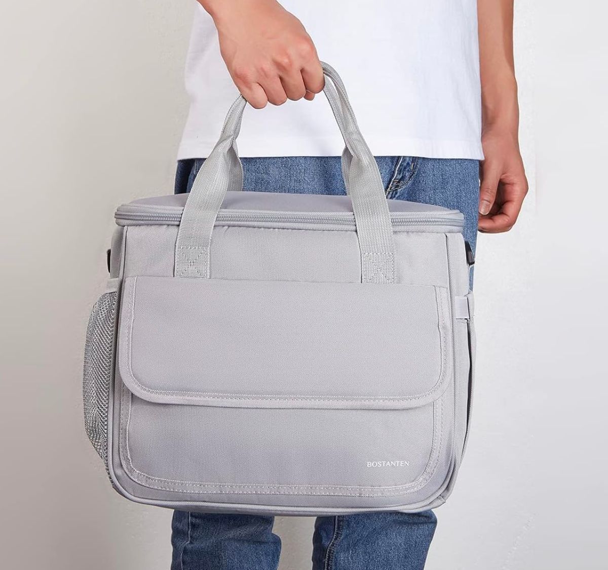man carrying gray cooler bag