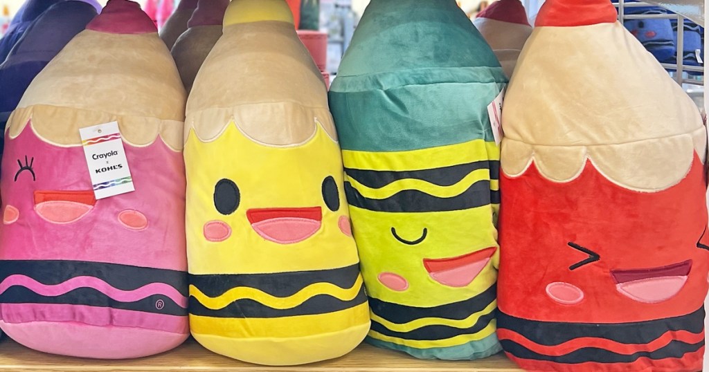 pink, yellow, green, and red crayon pillows on store shelf
