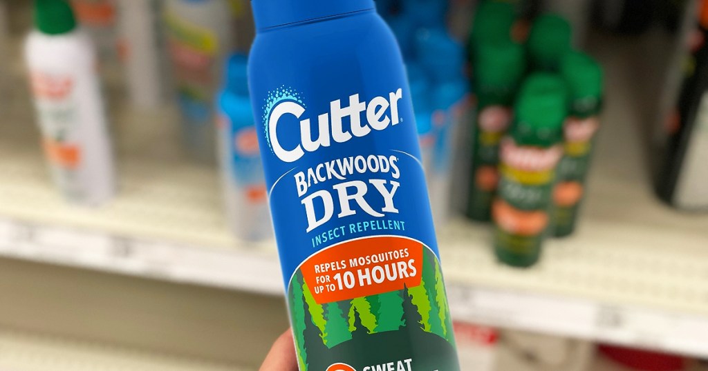 hand holding a blue bottle of Cutter Backwoods Dry Insect Repellent