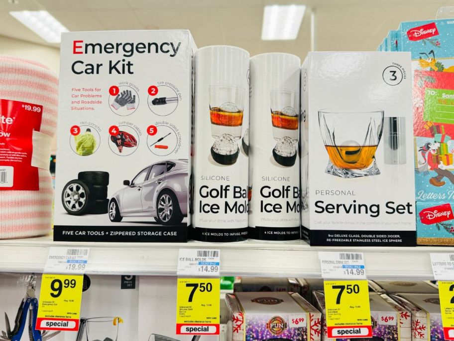 emergency car kit, golf ball ice mold, and personal serving set boxes on shelf in store