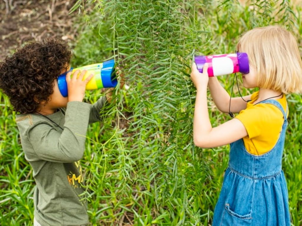 two kids using GeoSafari Jr. Kidnoculars Binoculars