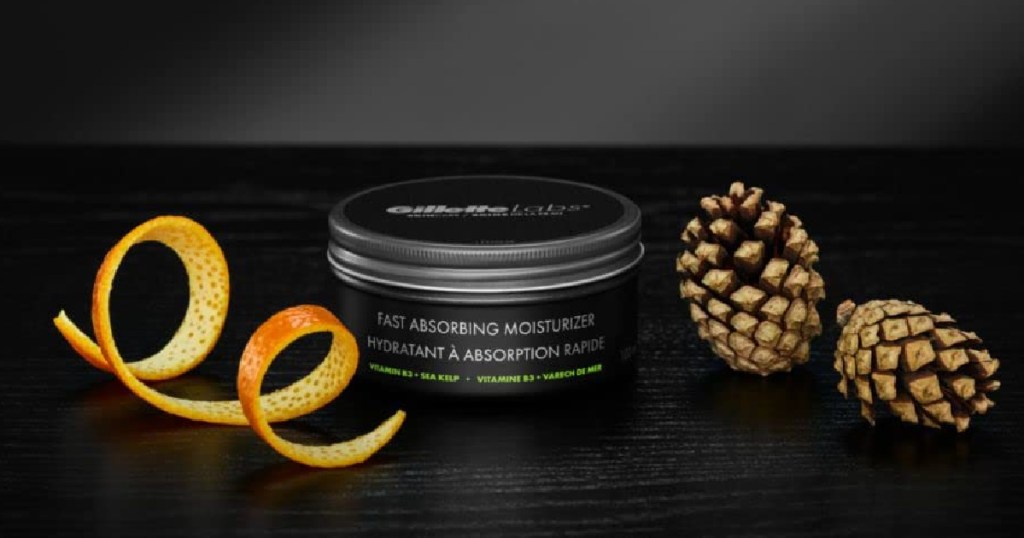 Gillette Labs Men's Moisturizer Cream surrounded by an oragen peel and pine cones