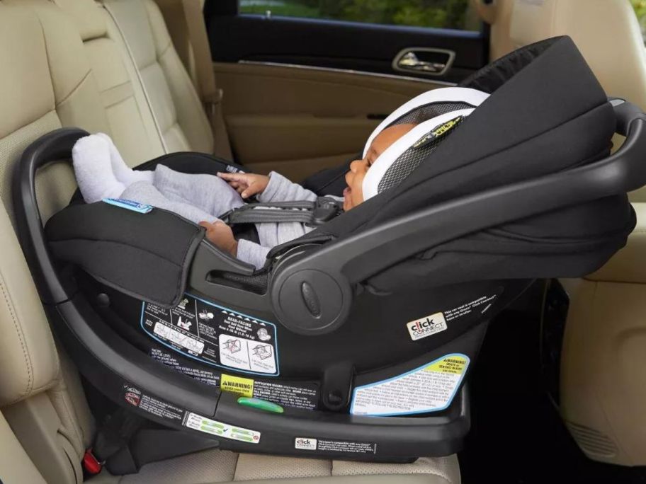 Graco SnugRide SnugFit 35 DLX Infant Car Seat w/ Safety Surround in car with baby in it