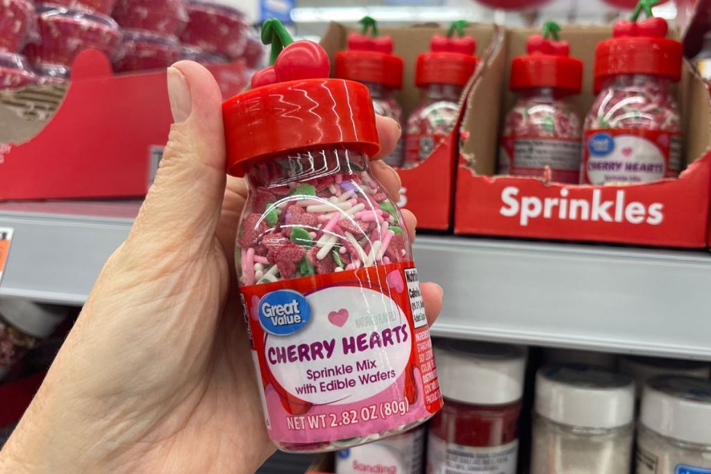 a womans hand holding a Great value Cherry hearts sprinkles in store