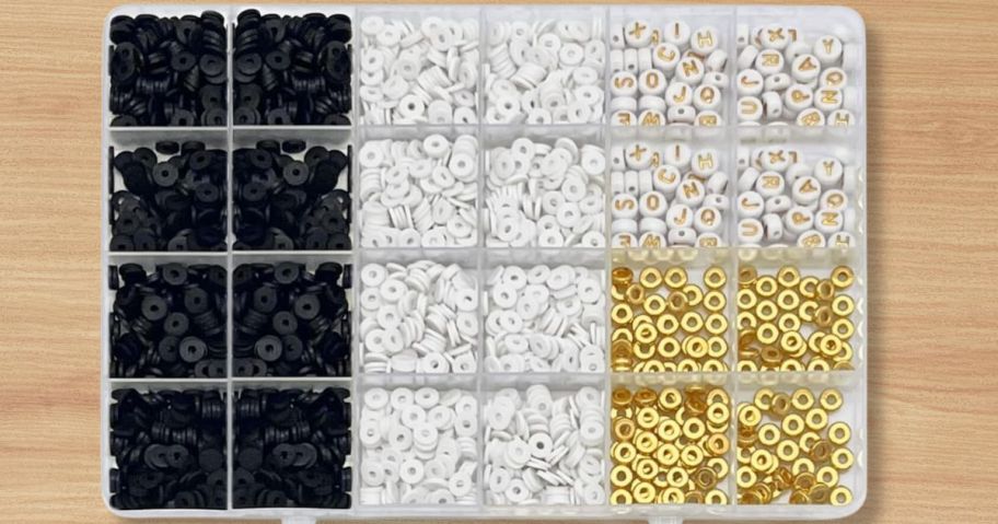 clear container with black, white and gold clay beads for a bracelet making kit