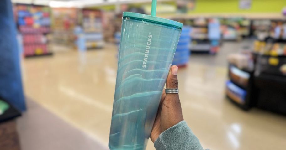 hand holding a Seafoam Green Shell Cold Cup 