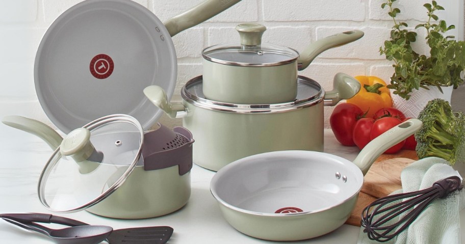 light cream T-fal cookware set with pots, pans, lids, and kitchen tools