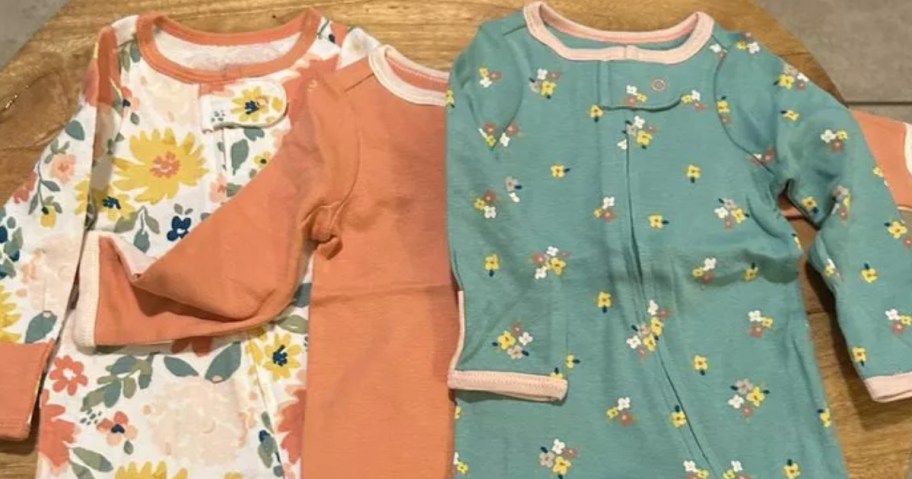 3 baby girl's sleepers in orange, green, pink, floral patterns and solids