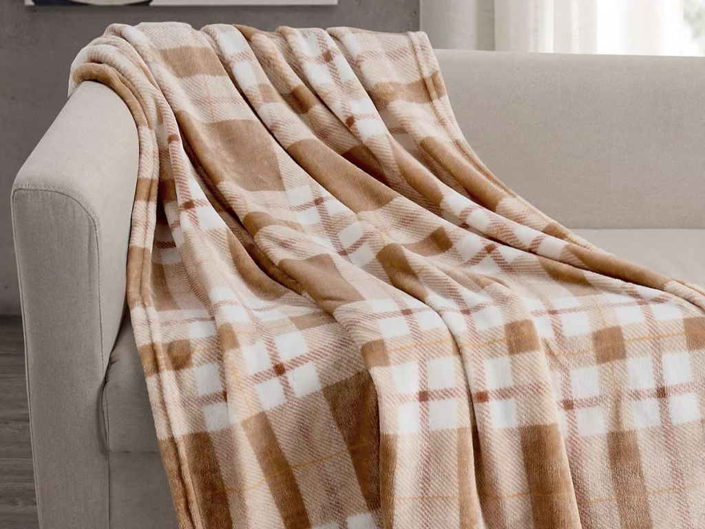 tan/brownish and off white plaid throw blanket over a tan couch