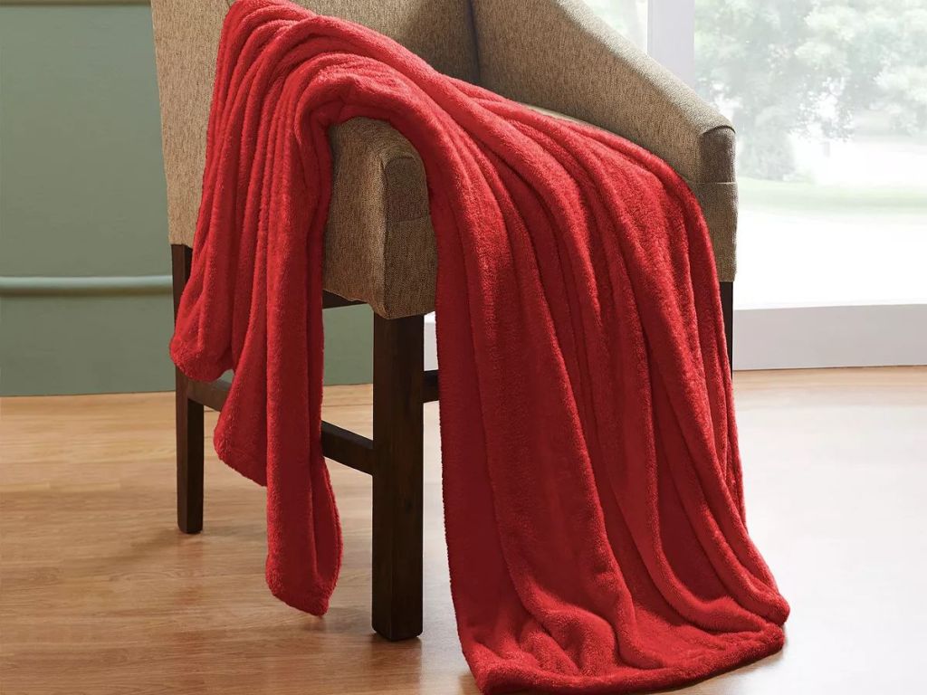 red plush throw blanket over a tan chair