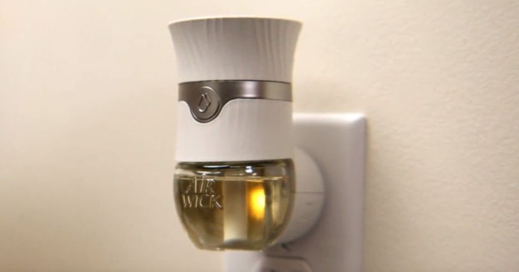 Airwick scented oil plugin shown plugged into wall outlet