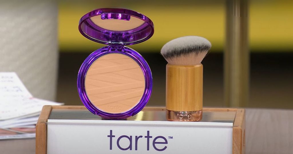 tarte pressed powder shape tape and angled brush on display with a tarte sign