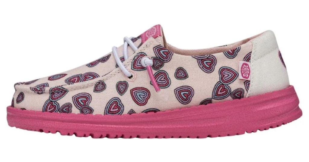 kid's Hey Dude shoe with pink sole and pink and black hearts on the shoe